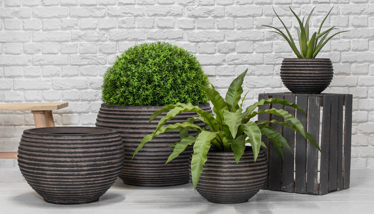 a selection of beautiful plant pots with artificial plants in